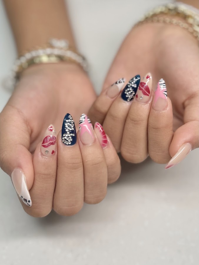 Detailed nail art at A & J Nails Spa — stiletto nails with rhinestones, hearts and hand-painted accents