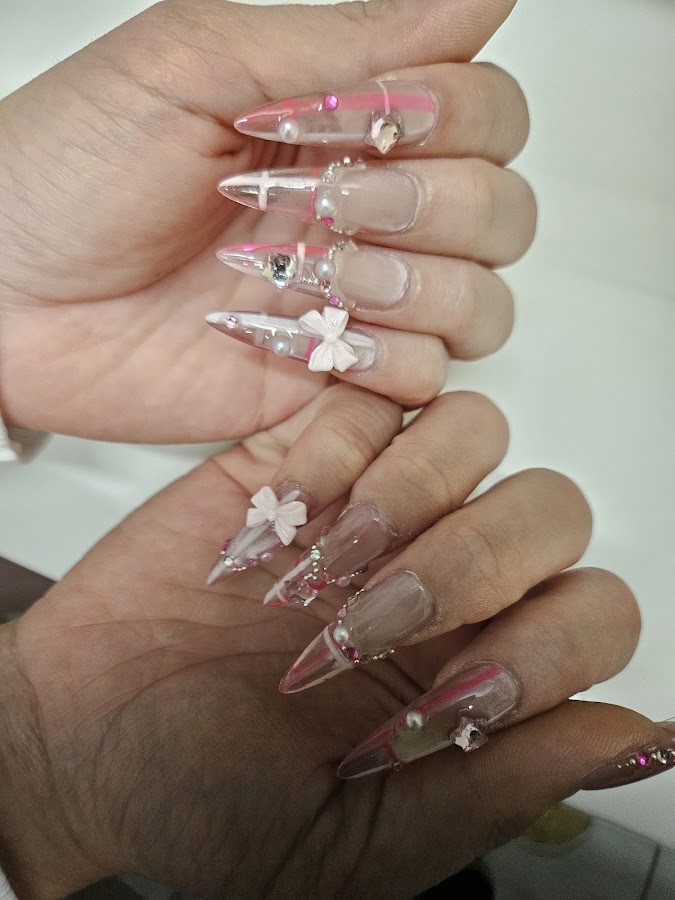 Clear and pink stiletto nails with 3D bows, pearls and rhinestones