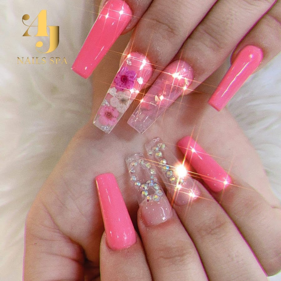 Glossy pink coffin nails with pressed flowers and crystal detailing by A & J Nails Spa